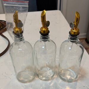 Set of Three Glass Bottles with Gold Pour Spouts